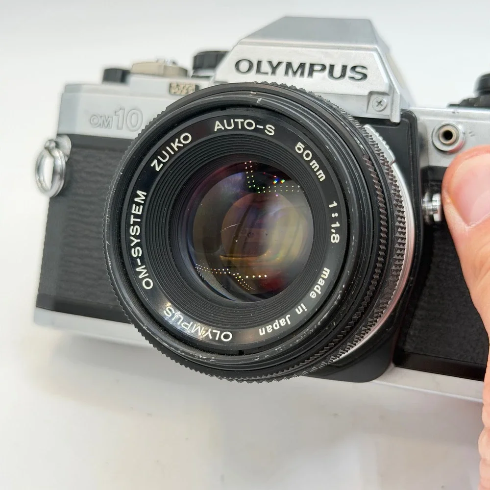 Olympus OM10 35mm Film SLR Camera with Zuiko Auto-S 50mm f1.8 Lens Silver Black